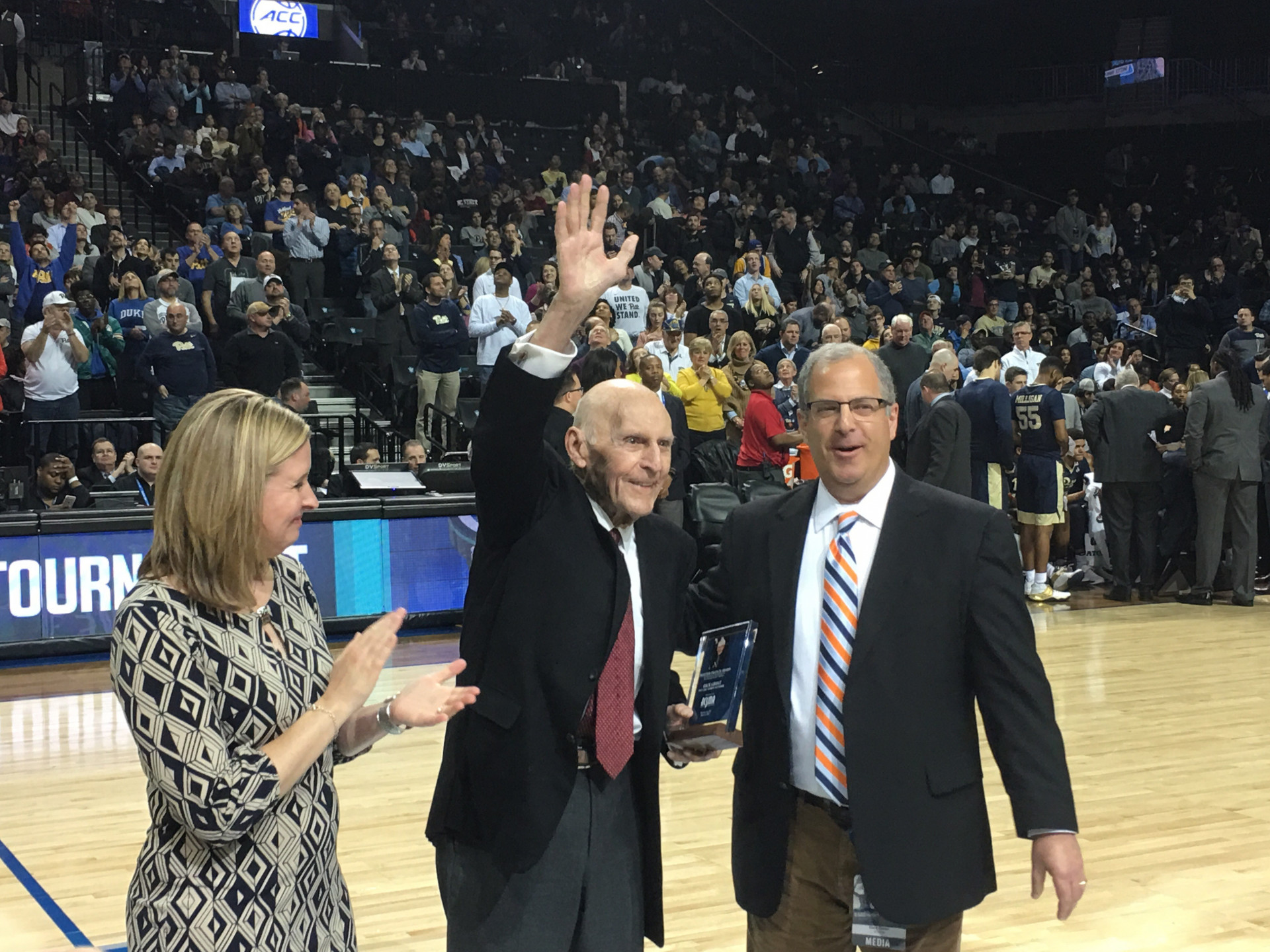 Dick Groat (center) waves to the crowd at the ACC Tournament in Brooklyn, NY, after receiving the Skeeter Francis Award for contributions to coverage of the ACC